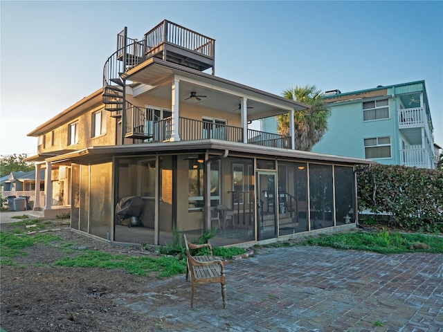 back of property featuring a patio area, a sunroom, and ceiling fan