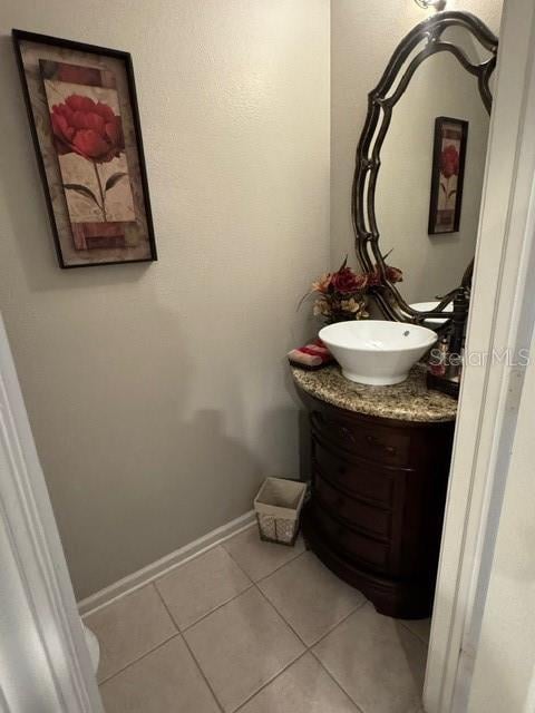 bathroom with tile patterned flooring and vanity