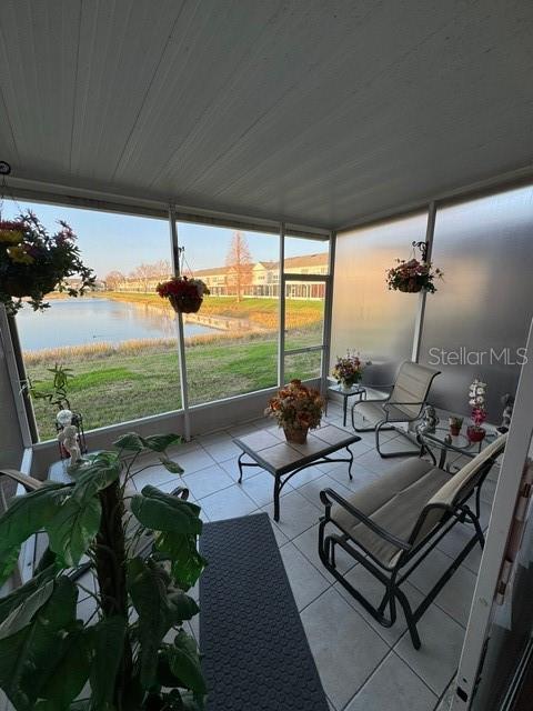 sunroom with a water view and wood ceiling