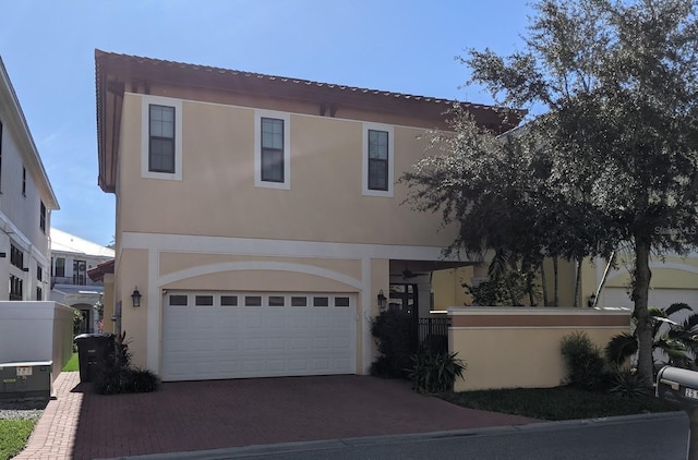 mediterranean / spanish home featuring a garage