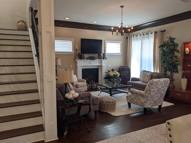 living room with ornamental molding, a chandelier, and dark hardwood / wood-style flooring