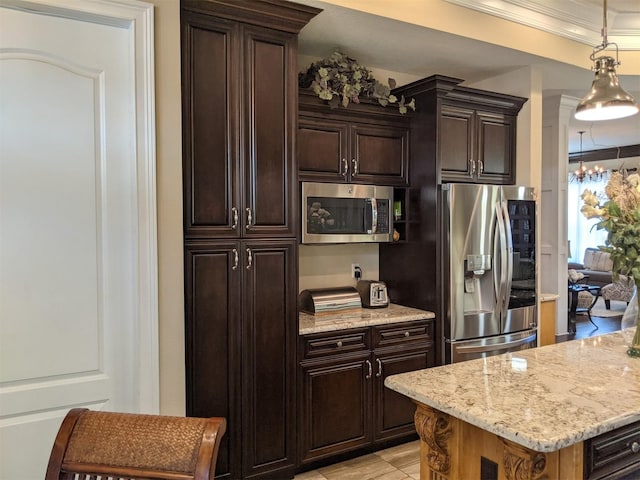 kitchen with crown molding, appliances with stainless steel finishes, light stone countertops, and dark brown cabinets