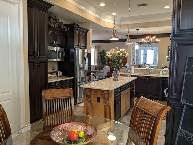 kitchen featuring a kitchen island, sink, ornamental molding, a tray ceiling, and stainless steel appliances