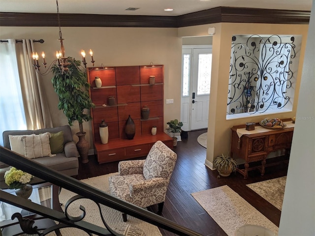 interior space featuring an inviting chandelier, ornamental molding, and dark hardwood / wood-style floors