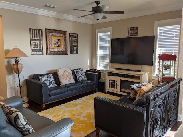 living room with crown molding and ceiling fan