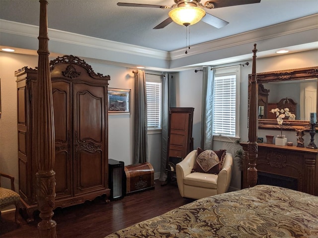 bedroom featuring dark hardwood / wood-style flooring, crown molding, and ceiling fan