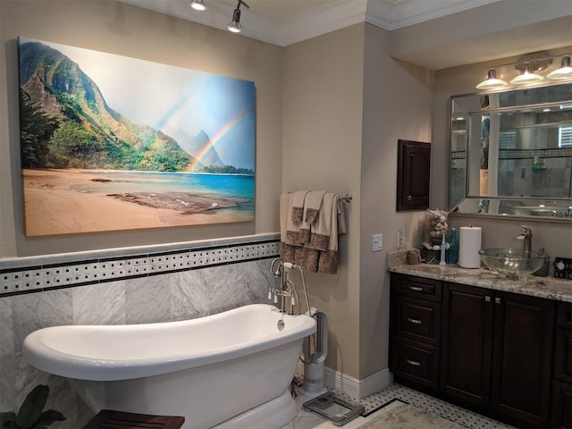 bathroom with crown molding, a washtub, and vanity