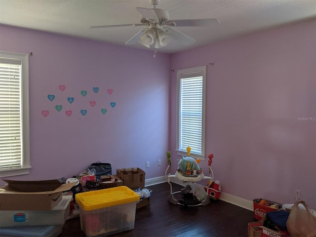 recreation room featuring dark wood-type flooring and ceiling fan