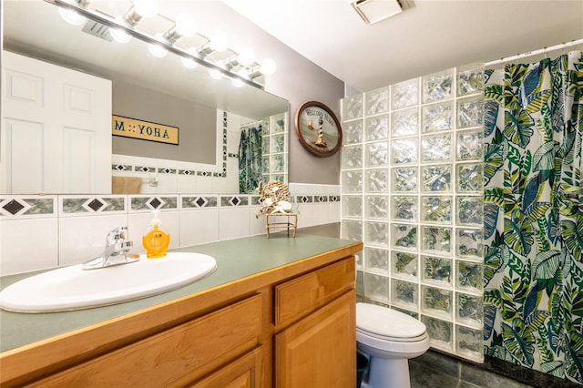 1849 Abrico Dr Unit 4, Lutz, FL 33558 - full bathroom featuring tile walls, vanity, toilet, curtained shower, and tile patterned floors