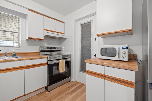 kitchen featuring light wood-style flooring, electric range, white microwave, white cabinets, and under cabinet range hood