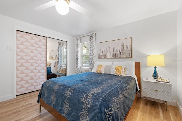 bedroom with a ceiling fan, baseboards, and wood finished floors