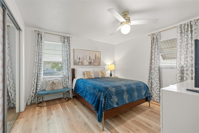 bedroom with light wood-style flooring, a closet, and a ceiling fan