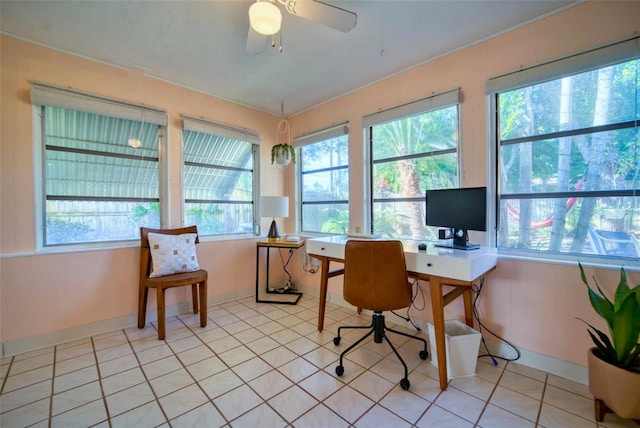 home office with a ceiling fan, baseboards, and light tile patterned floors