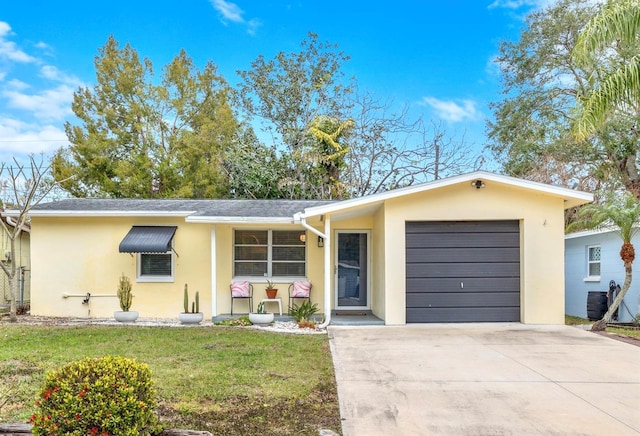 ranch-style home featuring stucco siding, a front lawn, concrete driveway, and an attached garage