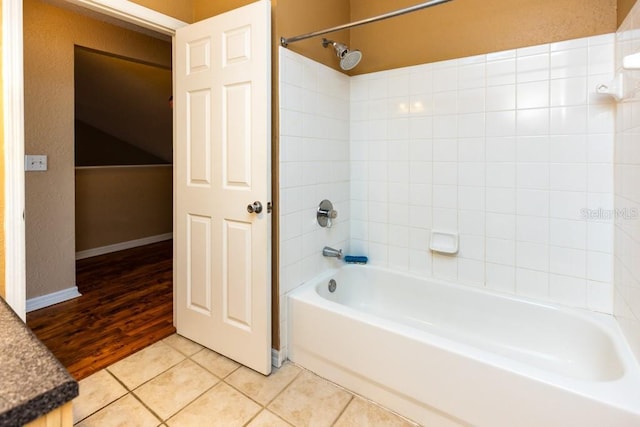 bathroom with tiled shower / bath and tile patterned floors