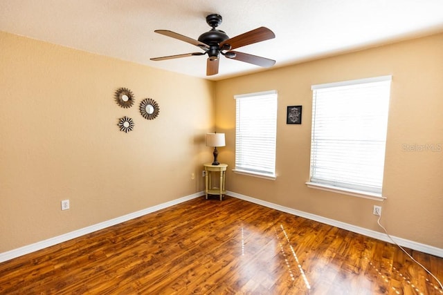 unfurnished room with ceiling fan and dark hardwood / wood-style floors