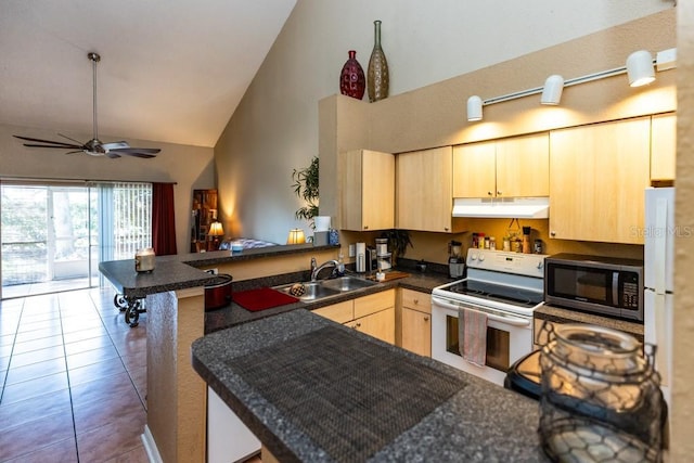 kitchen featuring high vaulted ceiling, light brown cabinetry, sink, electric range, and kitchen peninsula