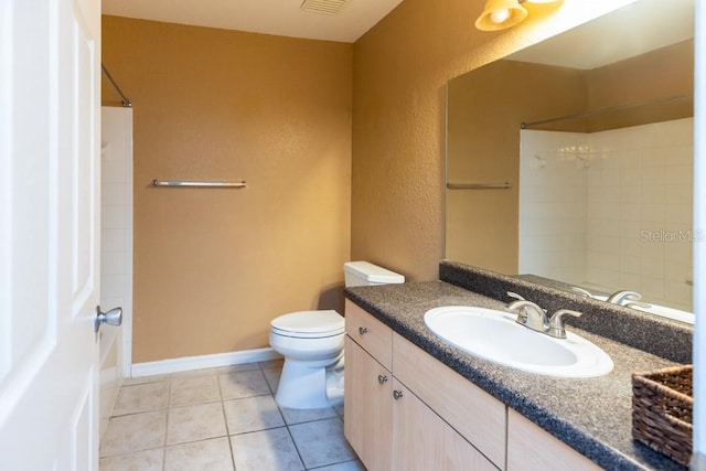 bathroom featuring vanity, tile patterned floors, toilet, and walk in shower