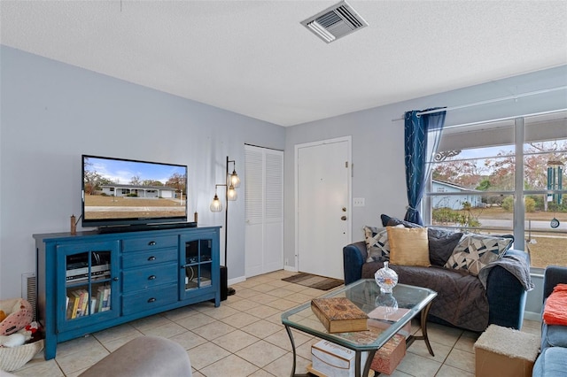 tiled living room with a textured ceiling