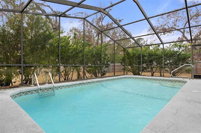 view of swimming pool featuring a lanai