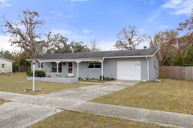 ranch-style house featuring a garage, a front yard, and covered porch