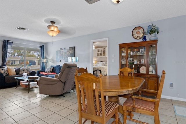 dining space with light tile patterned floors and a textured ceiling