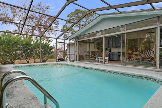 view of swimming pool featuring a patio and a lanai