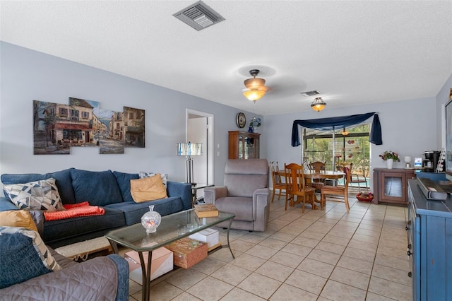 living room featuring light tile patterned floors and a textured ceiling