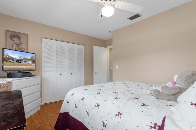 bedroom with a closet, ceiling fan, and light hardwood / wood-style flooring