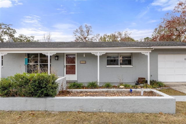 single story home with a garage and a porch