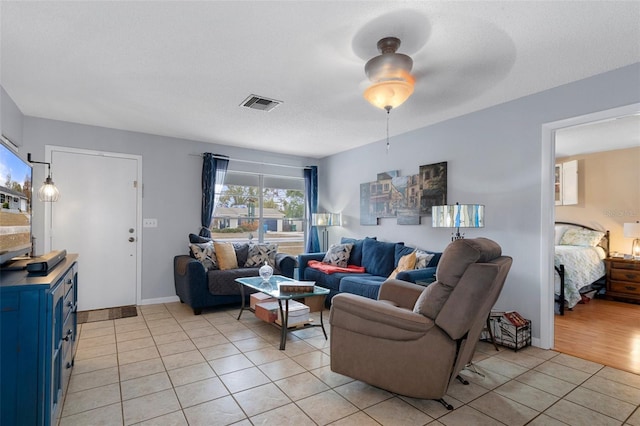 tiled living room with a textured ceiling