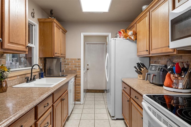 kitchen with white appliances, sink, decorative backsplash, and light tile patterned floors