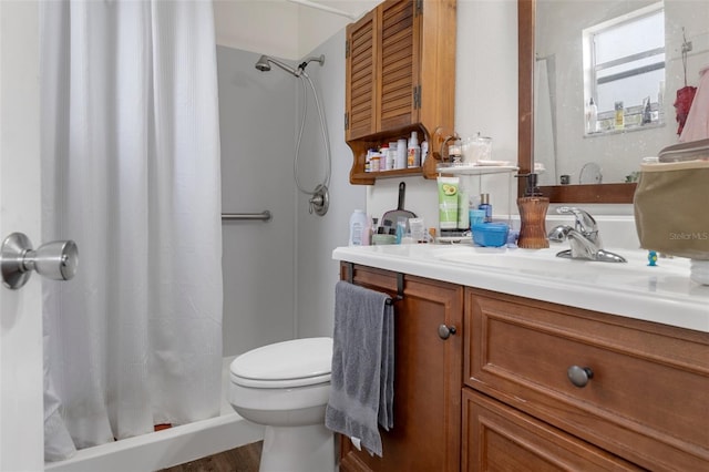 bathroom featuring vanity, curtained shower, and toilet