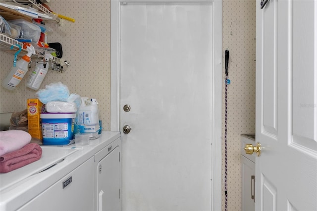 clothes washing area featuring washer and clothes dryer