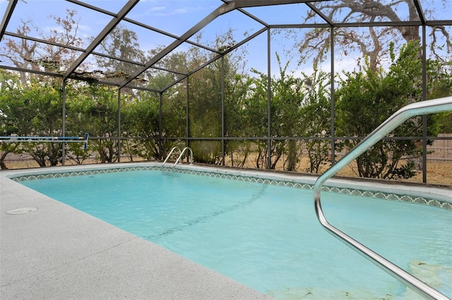 view of pool featuring glass enclosure