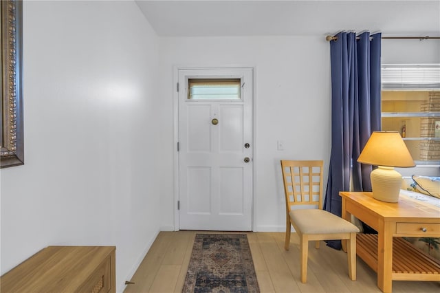 entryway with light wood-type flooring and baseboards