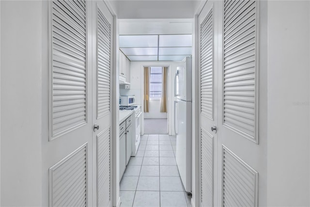 hallway with light tile patterned floors