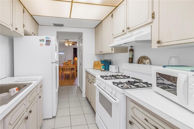 kitchen with under cabinet range hood, visible vents, white appliances, and light countertops