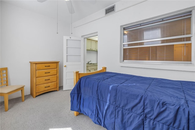 bedroom with light carpet, ceiling fan, and visible vents