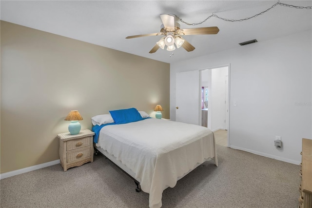 bedroom with light carpet, a ceiling fan, visible vents, and baseboards