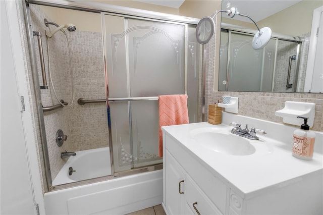 full bath with bath / shower combo with glass door, decorative backsplash, and vanity