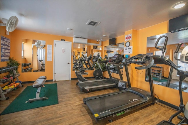 workout area with visible vents and wood finished floors