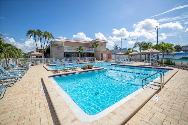 pool featuring a gazebo, a patio area, and fence