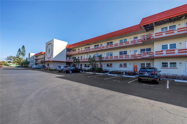 view of building exterior featuring uncovered parking