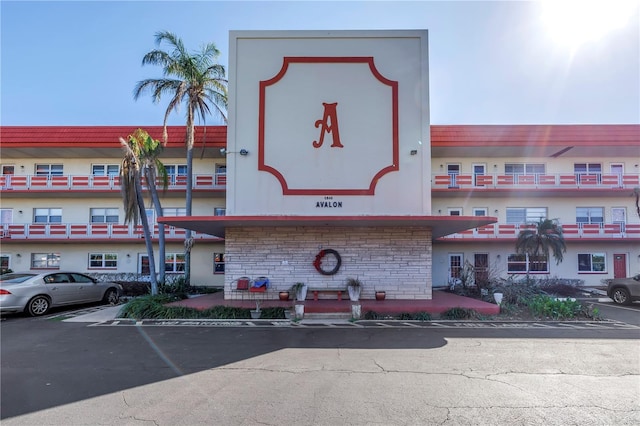 view of building exterior with uncovered parking