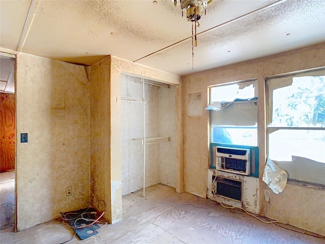 interior space featuring cooling unit and a textured ceiling