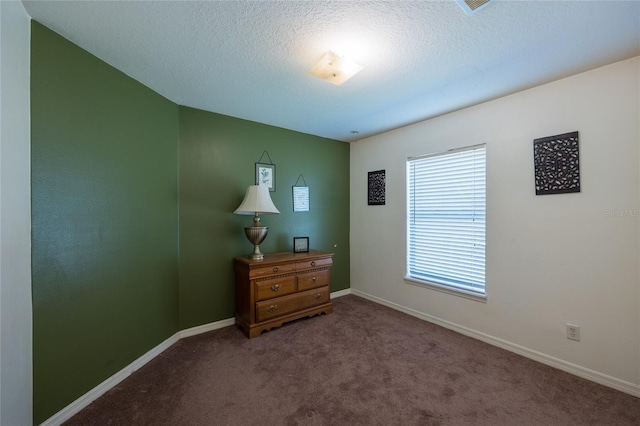 bedroom with carpet floors and a textured ceiling