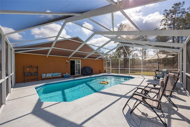 view of pool with a patio and glass enclosure