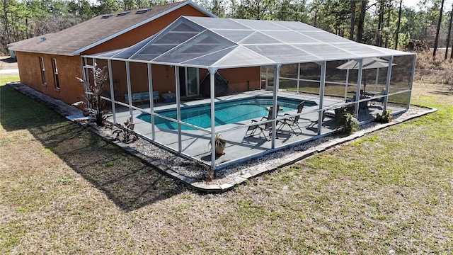 view of swimming pool with a lanai, a lawn, and a patio area