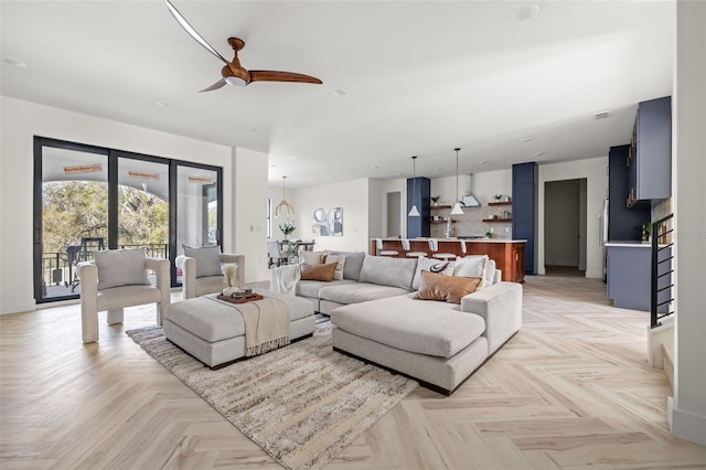 living room with ceiling fan and light parquet floors